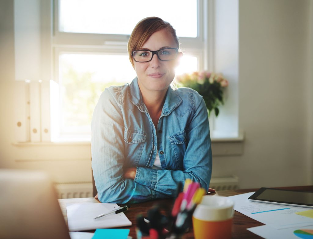 Successful,business,woman,working,at,the,office,looking,at,camera